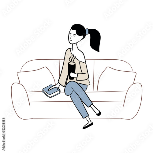 A woman is drinking coffee and reading a book on the couch. Enjoy the peace and quiet at home. Concept of homeward and comfort. Coffee and book. Relax and calm down. Cup of hot drink in hands.