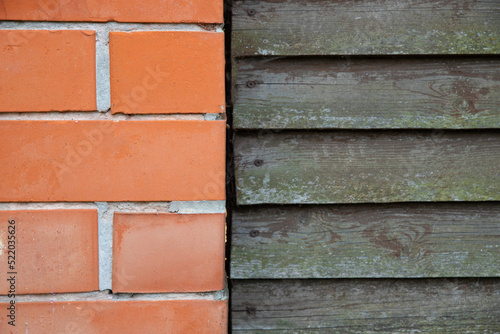 Background template wall fence made of orange bricks and gray boards