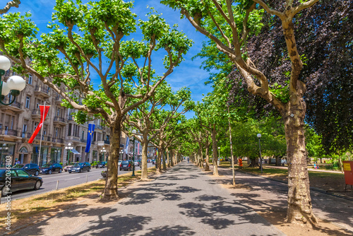 Lovely view of the Wilhelmstraße, a famous urban boulevard in Wiesbaden, state capital of Hesse, Germany. Opposite of the street are upmarket stores and shopping arcades.