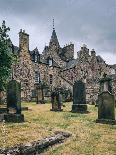 Edinburgh, Scotland, UK - July 2022: Gravestones on the graveyard behind Canongate Kirk on a cloudy afternoon