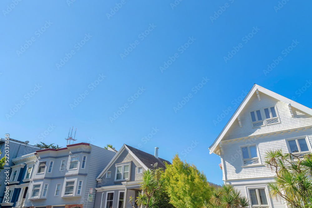 View of front exterior of houses from below against the clear blue sky in San Francisco, CA View of front exterior of houses from below against the clear blue sky in San Francisco, CA