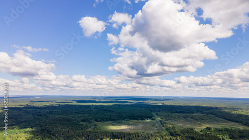 Blue sky panorama with clouds over tops of green trees. Blue sky and white cloud soft. White clouds background. © kalyanby