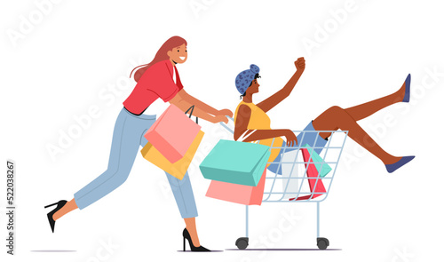 Couple of Women Fool in Supermarket Riding in Trolley. Happy Girl Pushing Shopping Cart with her Friend Sitting inside