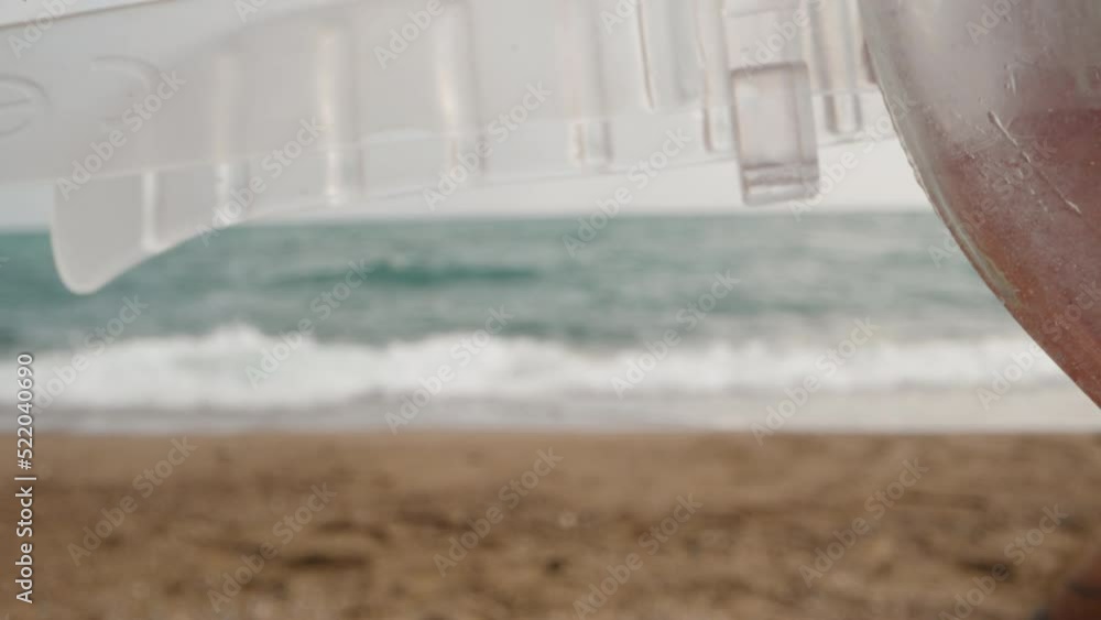 A man puts on a swimming mask, the camera goes between the face and the mask against the background of the sea. Dolly slider extreme close-up. A man puts on a swimming mask, the camera goes between the face and the mask against the background of the sea. Dolly slider extreme close-up.