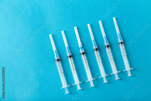 medicine, vaccination and healthcare concept - disposable syringes on blue background