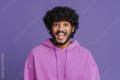 Photography Portrait of young indian handsome curly enthusiastic man