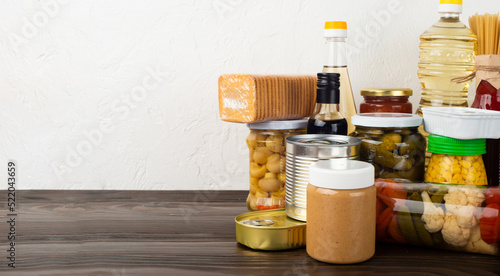 Emergency survival food set on dark wooden kitchen table photo