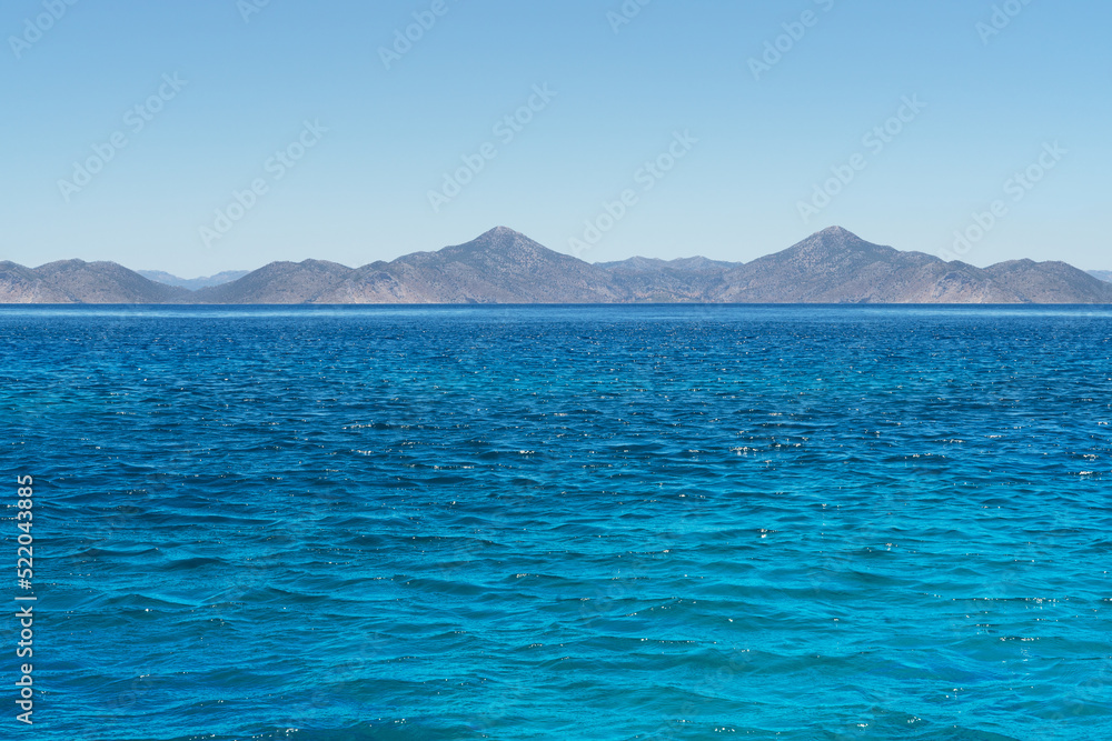Beautiful emerald Sea with mountains in the background.