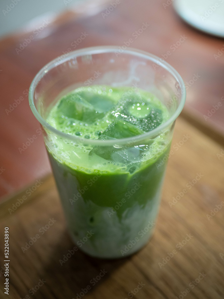 ice green tea matcha with milk on wooden table in cafe ice green tea matcha with milk on wooden table in cafe