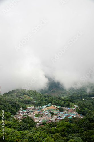 view of the doi pui local countryside village among the mountain hill range surround with mist fog above cloud sky