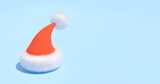 santa Claus's red hat isolated on a blue background, 3d render