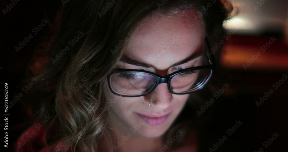 Girl typing on her cellphone in the back seat of a car at night Girl typing on her cellphone in the back seat of a car at night