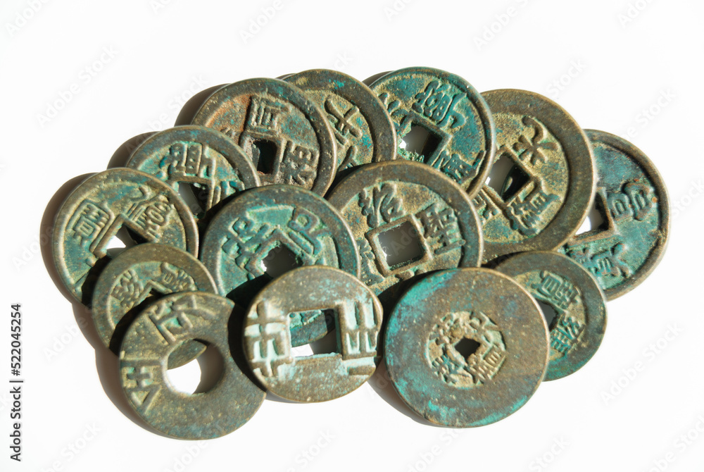 Many ancient Chinese coins on a white background Many ancient Chinese coins on a white background