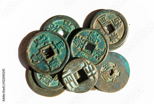 Many ancient Chinese coins on a white background
