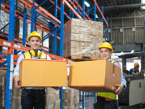 Male female man woman yellow hardhat helmet safety employee check order shelf shipping manager storage factory industry holding box logistic cargo supervisor engineer standing teamwork import export 