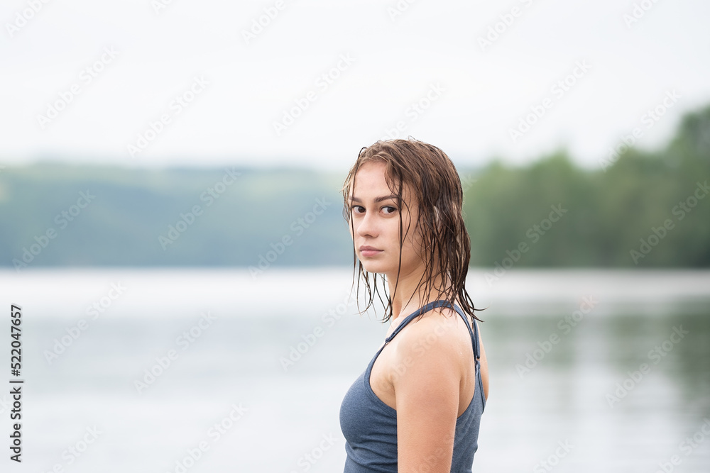 Beautiful slender girl doing yoga on a paddleboard. A young woman does water sports in the summer sunrise. Beautiful slender girl doing yoga on a paddleboard. A young woman does water sports in the summer sunrise.