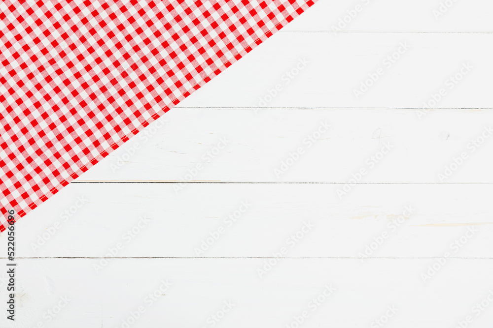 Clothes red and white on white background for a menu of a restaurant with copy space. Top view fabric tablecloth on old white wood background. Flat lay checked fabric old wooden. Clothes red and white on white background for a menu of a restaurant with copy space. Top view fabric tablecloth on old white wood background. Flat lay checked fabric old wooden.