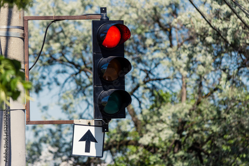 Traffic semaphore with red light for those that drive ahead in intersection