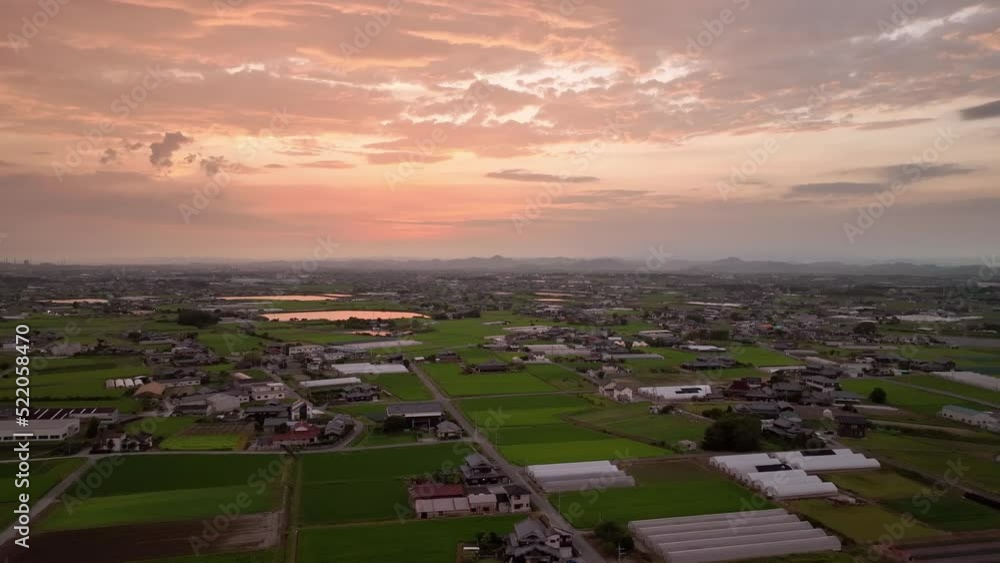 Dramatic sunset over greenhouses and rice fields in rural Japan Dramatic sunset over greenhouses and rice fields in rural Japan