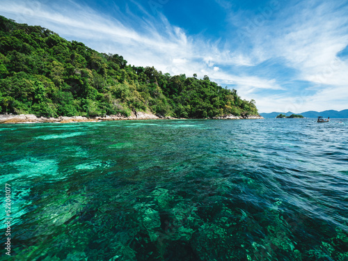 Scenic view of Koh Mai Phai Island crystal clear turquoise sea water with coral reef transparent. Snorkeling spot. Near Koh Lipe Island, Tarutao National Marine Park, Satun, Thailand.
