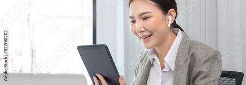 Business woman using a tablet to work in the office., World of technology and internet communication, Using tablet to conduct financial transactions because the convenience and speed..