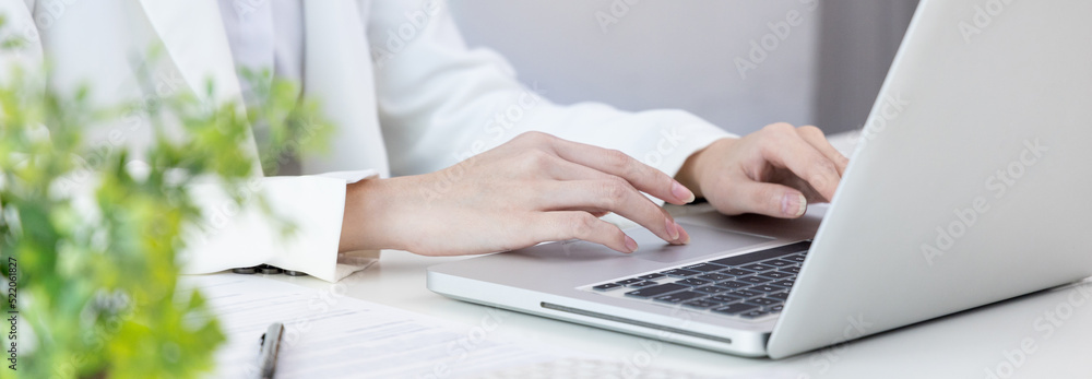 Businesswoman's hand presses on a laptop keyboard, World of technology and internet communication, Using computers to conduct financial transactions because the convenience and speed, Working concept. Businesswoman's hand presses on a laptop keyboard, World of technology and internet communication, Using computers to conduct financial transactions because the convenience and speed, Working concept.