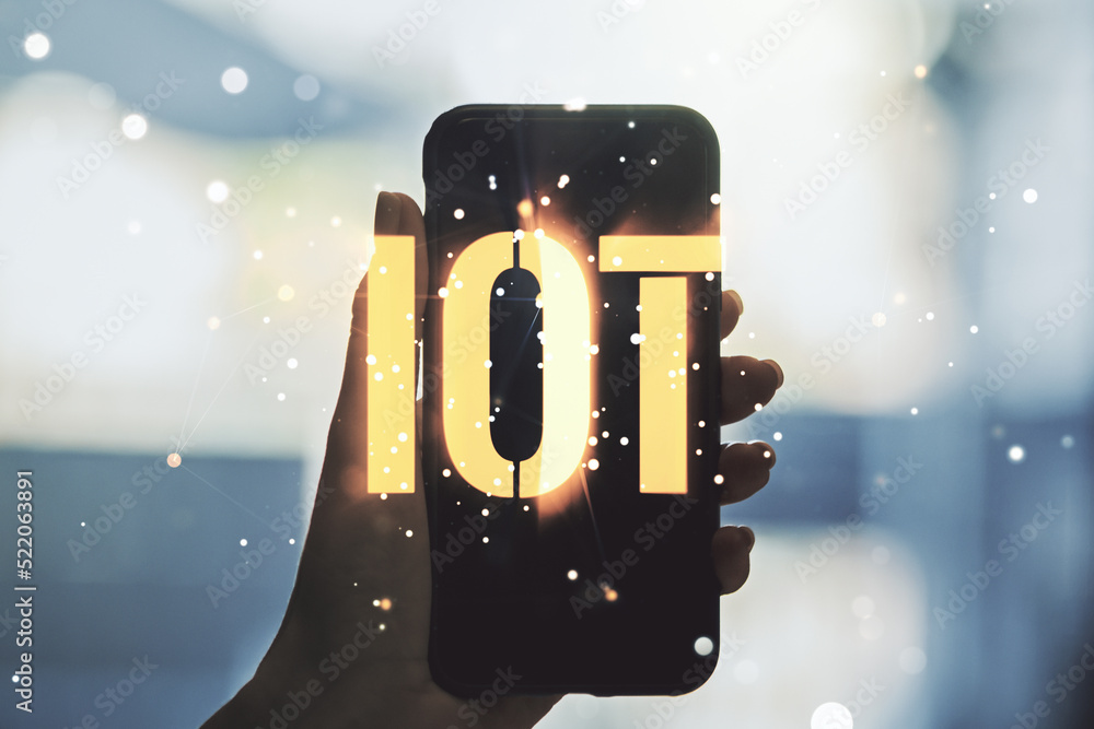 Naklejka premium Creative IOT concept and hand with phone on background. Multiexposure