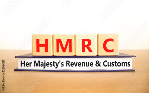 HMRC her majestys revenue and customs symbol. Concept words HMRC her majestys revenue and customs on blocks on beautiful white background. Business HMRC revenue and customs concept. Copy space. photo