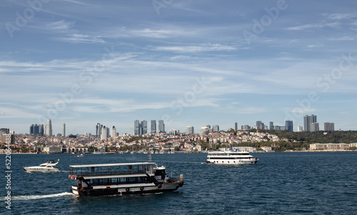 View of tour boats on Bosphorus and European side of Istanbul. It is a sunny summer day.