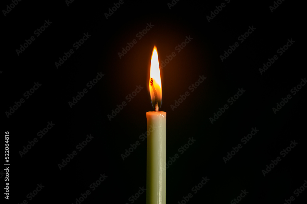 macro candle on black background,Flame of one white burning brightly wax candle on the dark black background . Mourning candle. Candle flame macro candle on black background,Flame of one white burning brightly wax candle on the dark black background . Mourning candle. Candle flame