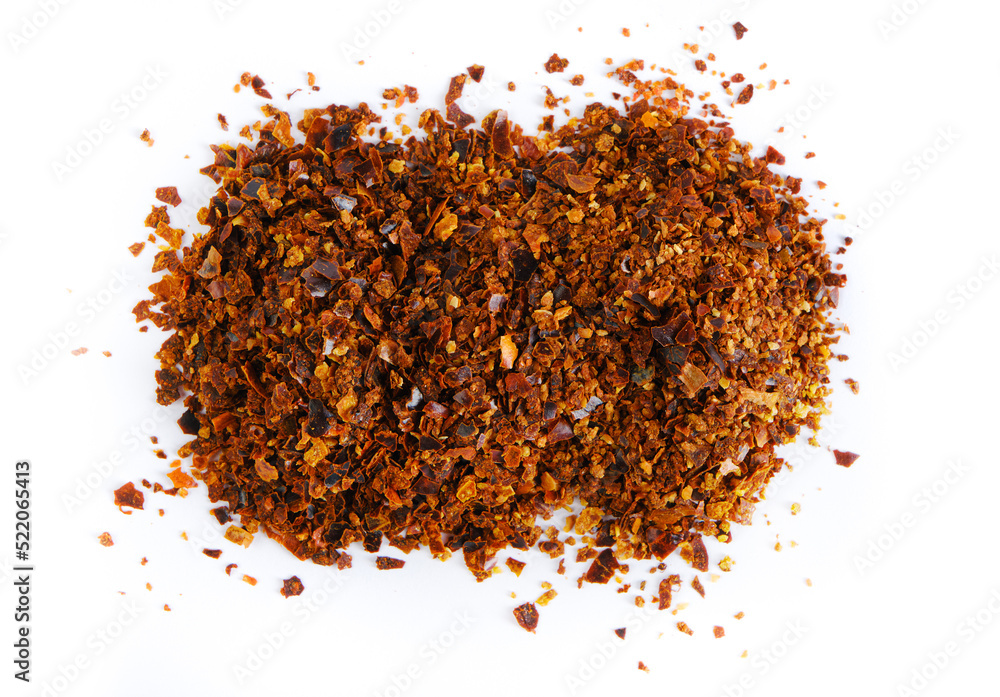 Ground chili pepper isolated on white background. Top view, close-up. Ground chili pepper isolated on white background. Top view, close-up.