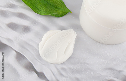 Cosmetic cream formulation image with a green background