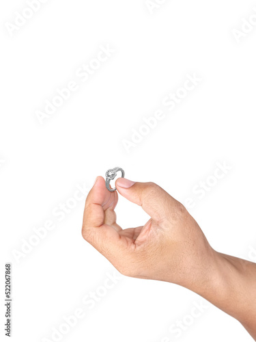 Hand holding diamond ring isolated on white background