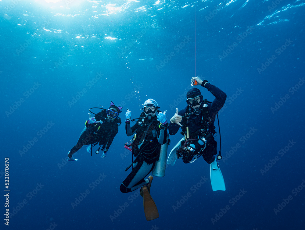 divers at safety stop in the tropical waters of the Andaman Sea divers at safety stop in the tropical waters of the Andaman Sea