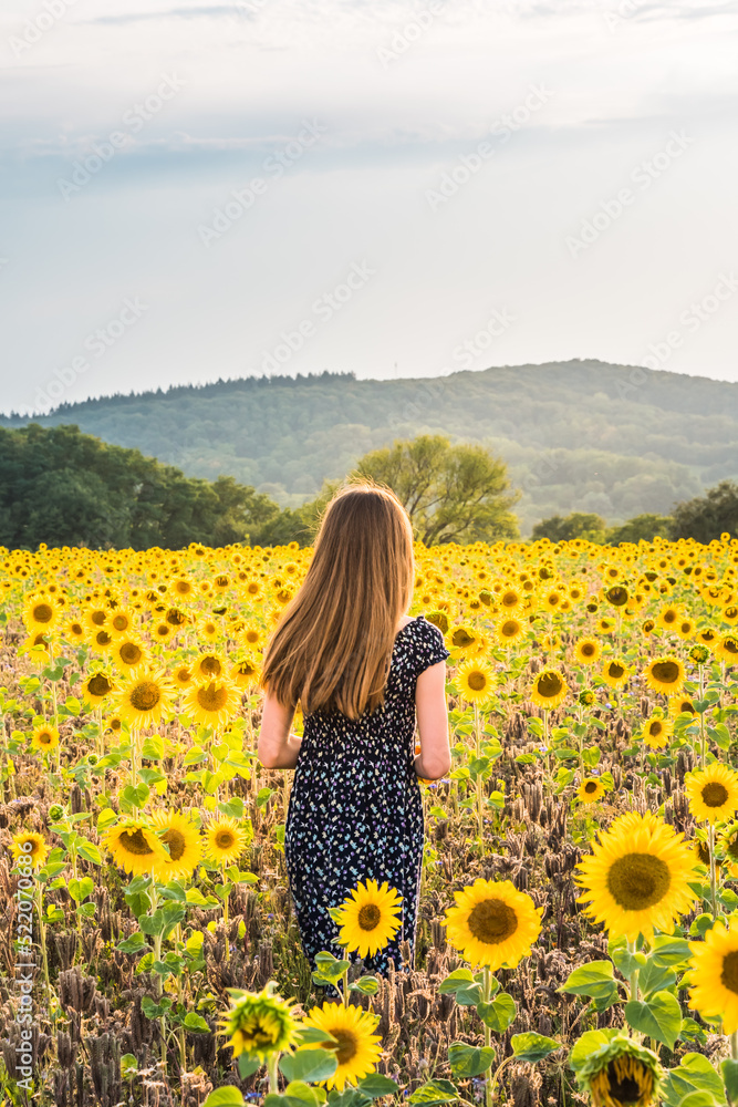 Teenage girl in sunflower field Teenage girl in sunflower field