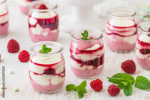 Fruity quark dessert with raspberries in small glasses