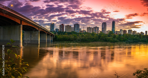Edmonton skyline and Groat Bridge at dramatic sunrise at Emily Murphy Park, over North Saskatchewan River in the Province of Alberta, Canada