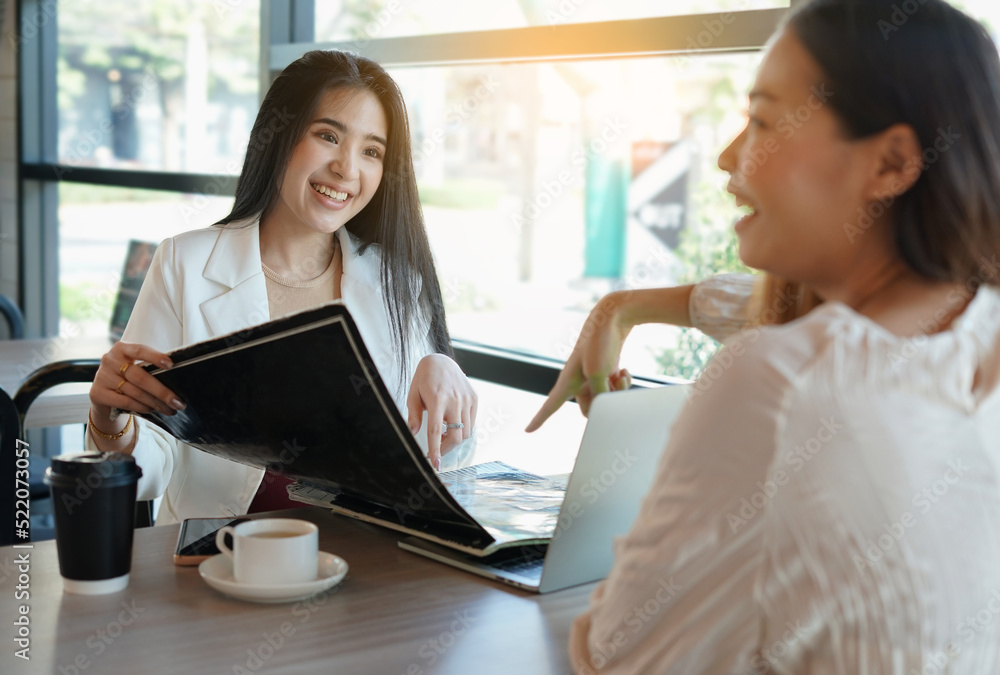 portrait business woman ordering food in the cafe, young happy asian women friends meeting and sitting by glass window