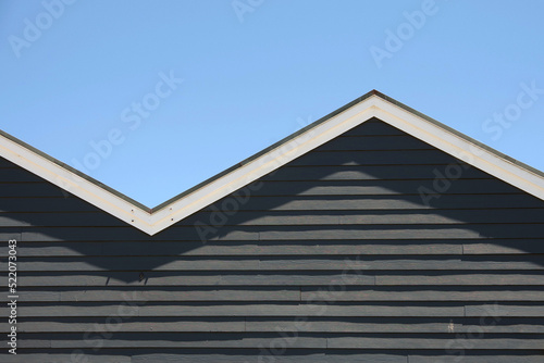 Obraz na plátne Zigzag shaped roof front under blue sky