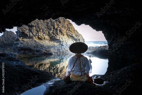 Papier peint Shugendo monk is sitting in cave and meditating while looking at open sea