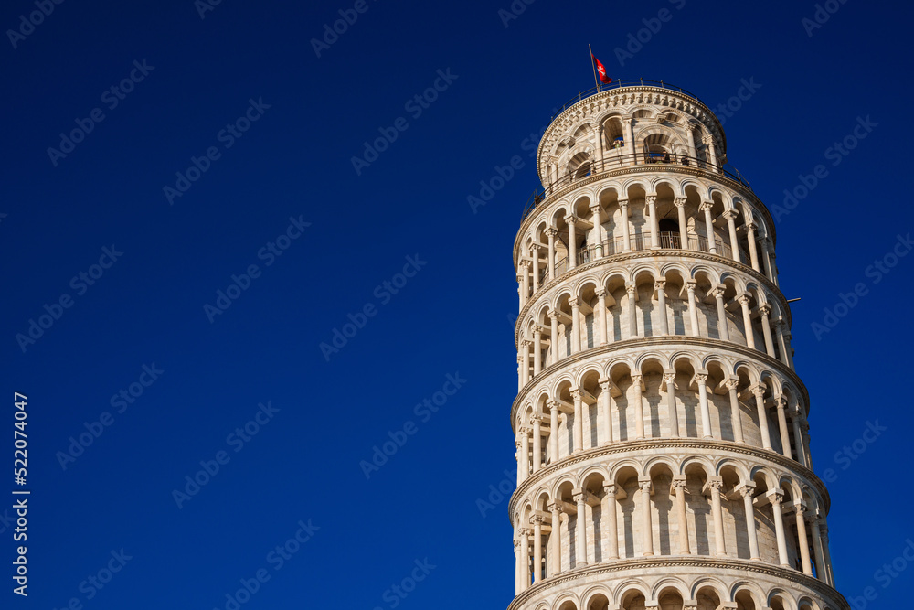 The iconic Leaning Tower of Pisa, one of the most famous ancient building in the world (with blue sky and copy space)