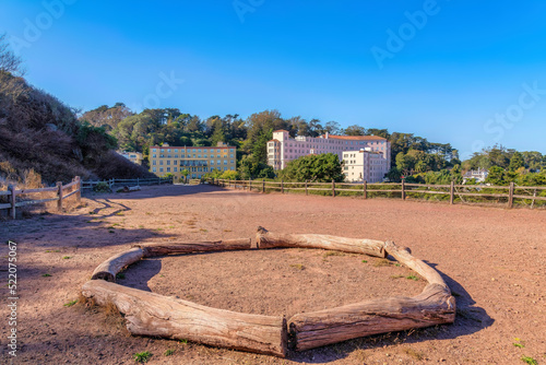 There are tree trunks forming a circle on a dirt ground at Corona Heights Park, San Francisco, CA photo