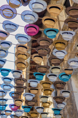 Hats in Avignon over a street