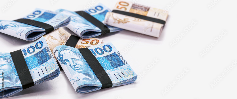 Brazilian real notes, 100 and 50 reais, ten thousand reais, millionaire grand prize, lottery or big luck. White background in copyspace Brazilian real notes, 100 and 50 reais, ten thousand reais, millionaire grand prize, lottery or big luck. White background in copyspace