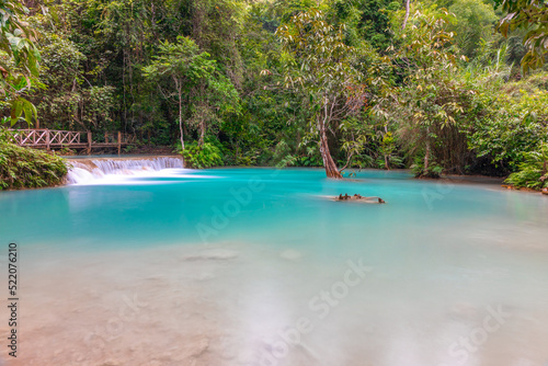 Magical turquoise blue colours of Kuang Si waterfalls Luang Prabang Laos. these waterfalls in the Mountains of Luang Prabang Laos flow all year round in the natural national park rainforest  © Elias Bitar