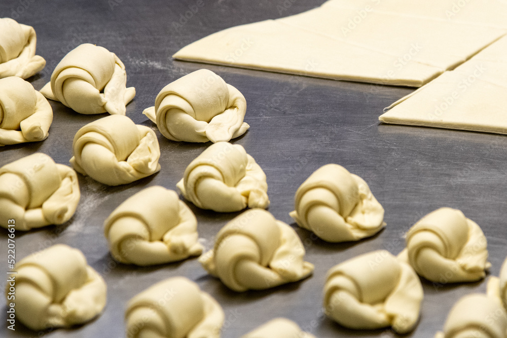 Handmade cocktail croissants being prepared, ready for baking
