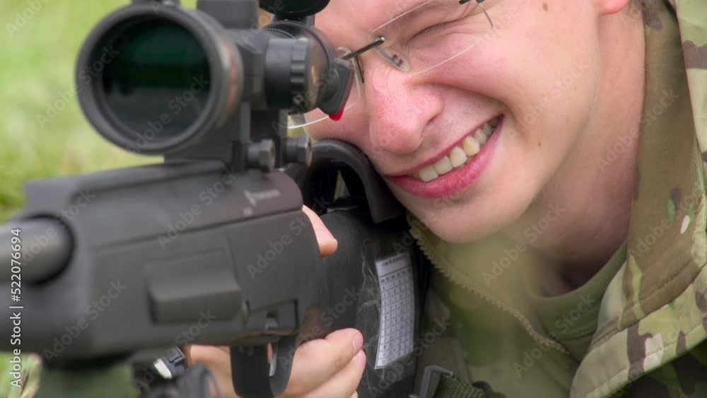 Sniper in Training Position. Shooting a sniper with a gun in position in a reportage style Sniper in Training Position. Shooting a sniper with a gun in position in a reportage style