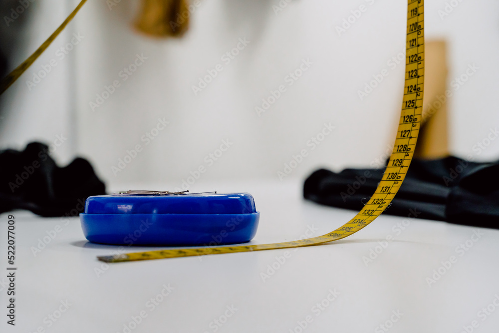 yellow meter for sewing and box of blue needles