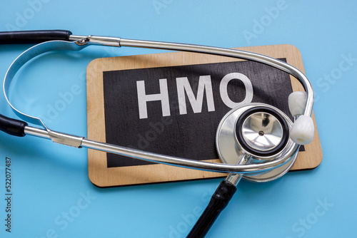 Plate with an inscription Health Maintenance Organization HMO and a stethoscope. photo