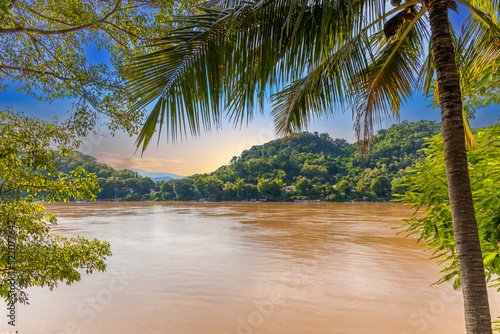 Luang Prabang Laos  beautiful river surrounded by lush green mountains and lovely historical houses